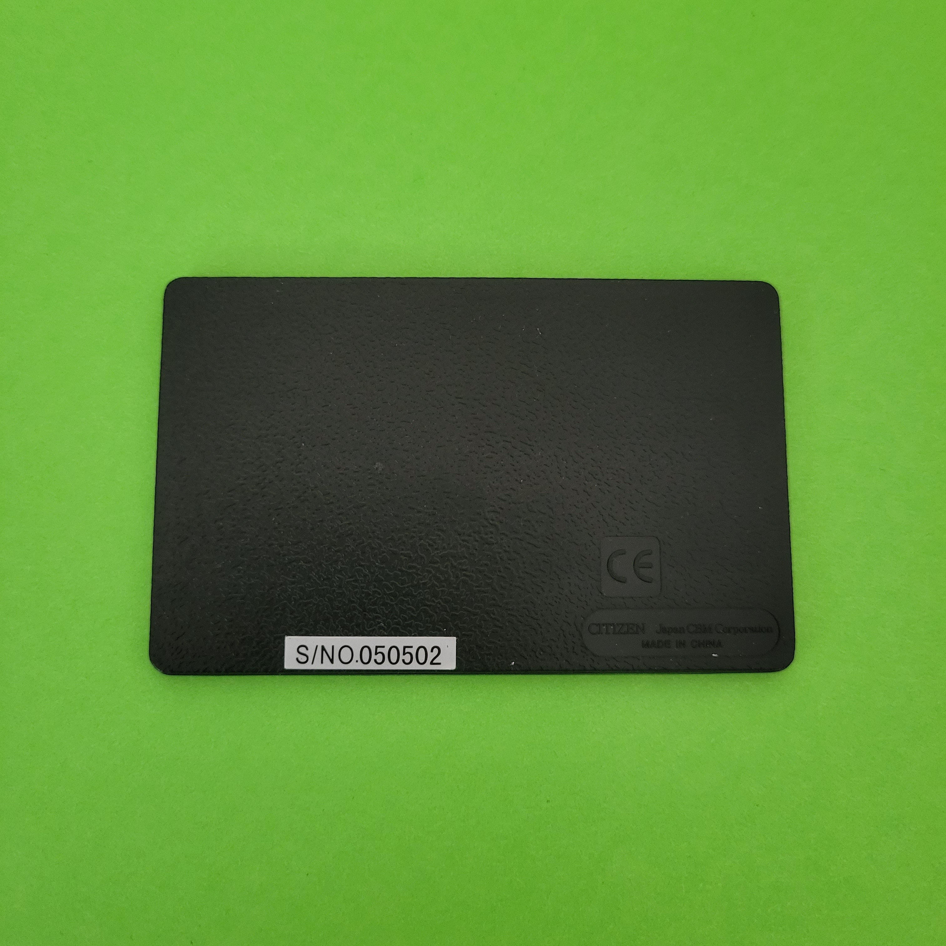 An image of the back of a citizen w11 four function + calculator